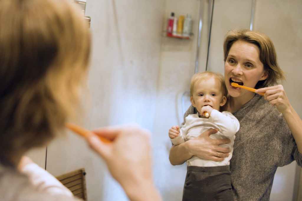 mother and child brushing teeth